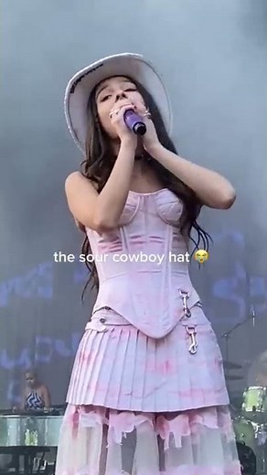 Olivia Rodrigo taking someone’s cowboy hat