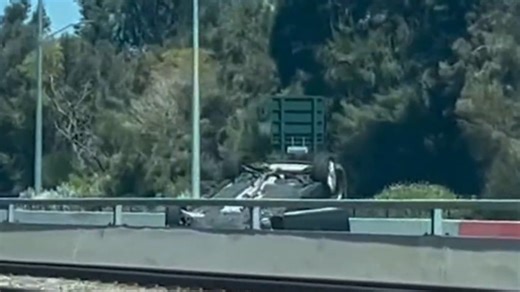 Allegedly stolen car ends on roof on Kwinana Freeway