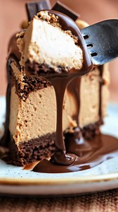 Chocolate Peanut Butter Mousse Cake-Don’t Lose This Recipe Silky layers · Deep cocoa · Buttery peanut warmth Have you ever tasted a cake so smooth it feels like it melts before you even swallow? This one carries that quiet magic — dark chocolate, gentle peanut butter, and a mousse so soft it barely holds its shape, all wrapped in a glossy ganache that drips like it knows it’s being watched. Don’t Lose This Recipe. What You’ll Need Chocolate Base Chocolate cookie crumbs Melted butter Peanut Butte