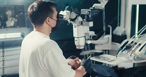 Dental work under a microscope with display. Dental treatment with a microscope. Reception at the dentist. Dental equipment.