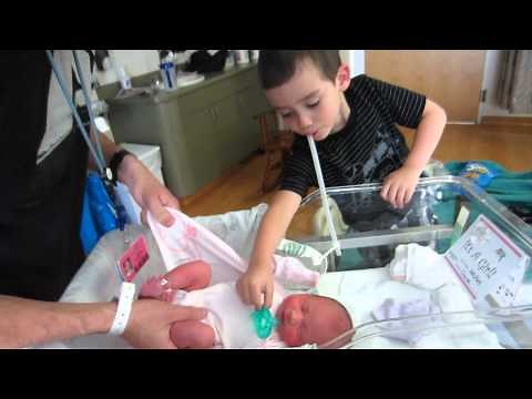 Newborn Isabelle getting dressed to come home