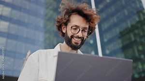 Young professional positive man working with laptop outside the office - Entrepreneur enjoying his job