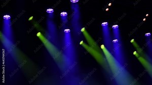 Spotlight slides of musical stage during the concert or show through the stage fog