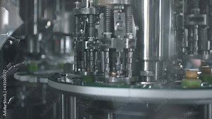 Robotic arm in smart factory automation line. packaging warehouse, processing facility. Glass bottles on conveyor belt in beverage factory. industry 4.0