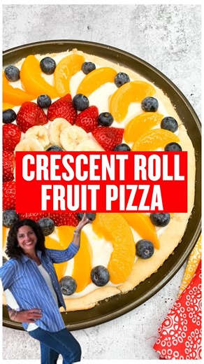 This delicious Crescent Roll Fruit Pizza is made with a cream cheese frosting base and topped with an assortment of fresh or canned fruit. Comment "RECIPE" for recipe link | Easy Family Recipes by Walking on Sunshine Blog