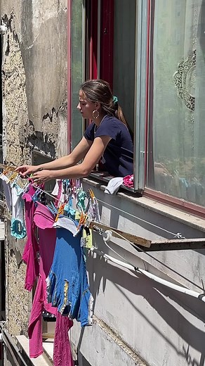 Hanging Laundry on a Clothesline in Urban Setting