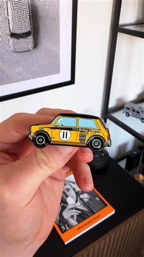 The Britax Downton Cooper race car, a BSCC hero! Check out the Classic Mini Cult enamel pin collection on our website, link in bio🏁 Featuring a print from @sh3dart in the background🤌 #classicmini #classiccars #britishsalooncarchampionship | Classic Mini Cult