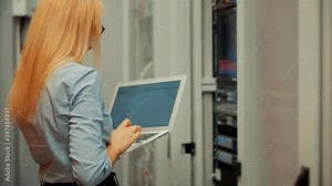 Woman It Engineer Working In Server Room.Network Engineer Work In Data Center.IT Technician Work With Rack Server Cabinet.Digital Secure Specialist In Data Center.It Administrator On Network Hardware