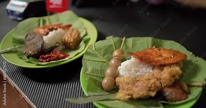 Payment for Nasi Jamblang typical of Cirebon, Indonesia in small sme restaurant use tapping cashless wifi qr code nfc scan app smart pos device reader sale in food drink order contactless.