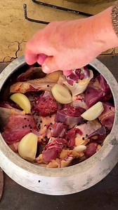 Savor the aroma of juicy turkey and onions cooking in a rustic cauldron over open flames. Tradition and flavor unite in this outdoor culinary experience. #OutdoorCooking #TraditionalRecipe #Cooking | SV Stories