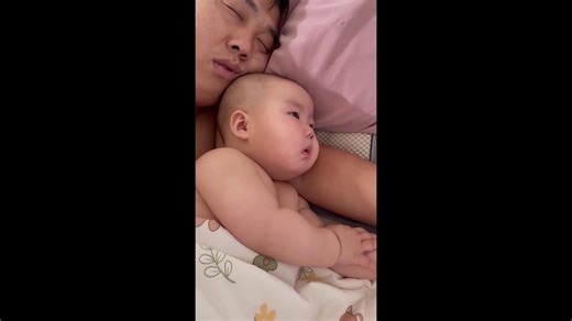 Father's loud snoring startles baby lying next to him