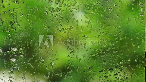 Close up Water Drops on window Glass on a rainy day, Water droplets on frosted glass walls or translucent windows get wet from the rain in the rainy season