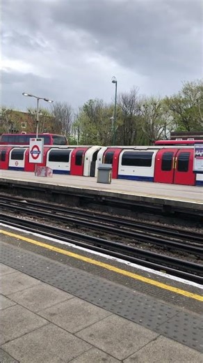 A beautiful Central line train is standing on the platform at Leytonstone station. #tflrail #travel
