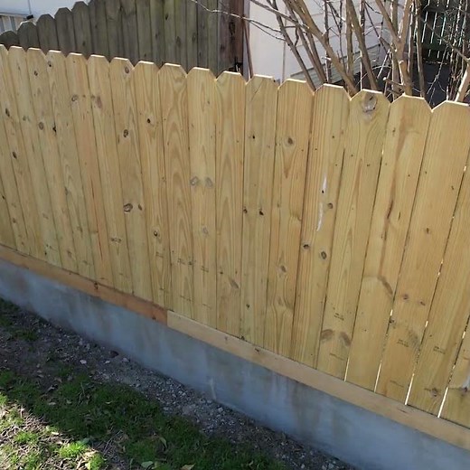 Privacy fence on a concrete retaining wall