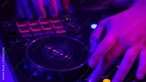 Close-up view of male hands, dj making sounds at night club party with professional sound mixer. Modern party style. Deep beats.