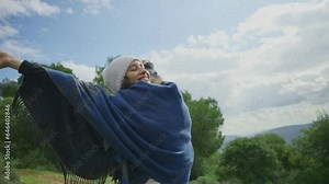 Happy and thankful young female hippie is grateful and joyous in nature outdoor. Living the moment care free and free spirit boho woman in a trip or hallucination or euphoria state in forest mountain