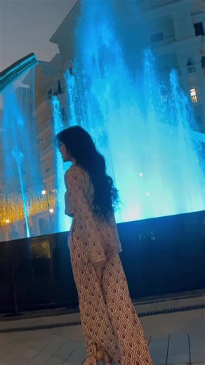 Charming Nighttime Fountain Display with Elegant Woman