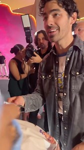 Joe signing stuff for fans last night at the AVA Resorts Grand Opening in Cancun. (10.26.24) 📸: @evelynblzc #JoeJonas #Jonas #JonasBrothers | Follow @jonasdailynews_ for more. | Jonas Brothers Daily News