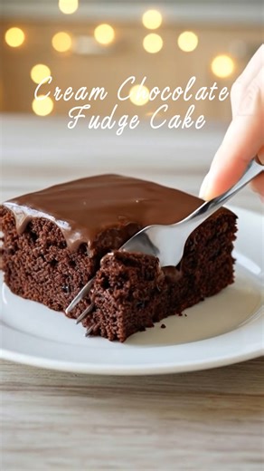 Cream Chocolate Fudge Cake Ingredients: - 1 cup salted butter (2 sticks) 🧈 - 1 cup water - 1/4 cup unsweetened cocoa powder 🍫 - 2 cups granulated sugar - 2 cups all-purpose flour - 1/2 teaspoon salt - 1 teaspoon baking soda - 1/2 cup sour cream - 2 large eggs - 1 teaspoon vanilla extract For the Fudge Frosting (9x13 pan amount): - 1/2 cup butter (1 stick) - 1/3 cup milk - 1/4 cup unsweetened cocoa powder - 3 3/4 cups powdered sugar - Dash of kosher or sea salt - 1 teaspoon vanilla extract Dire