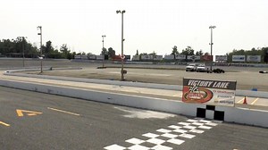 Owners of Sunset Speedway waving checkered flag
