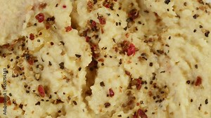 Israeli cuisine. Hummus texture decorated with spices close-up. National Food, middle eastern culture. Vegan chickpea puree snack. Appetizer made from mashed chickpeas.