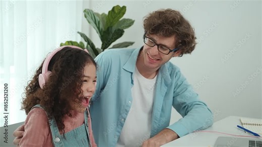 American daughter learning to coding and writing engineering prompt while positive smart father studying together and pointing at laptop screen to show programing code or system with care. Pedagogy.
