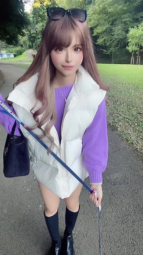 Woman Enjoys a Scenic Walk with Small White Dog