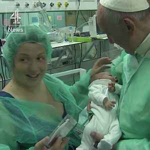 Pope Francis leaves a medallion in every incubator during a surprise visit to a neonatal ward in Rome. | Channel 4 News