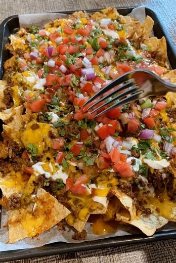 EPIC BEEF NACHO SUPREME Loaded, cheesy, and layered with seasoned beef and fresh toppings. Perfect for game night or a crowd. INGREDIENTS 1 pound ground beef 1 packet taco seasoning (or 2 tablespoons homemade) 1/2 cup water 1 (13-ounce) bag sturdy tortilla chips 2 cups shredded cheddar cheese 1 cup shredded Monterey Jack cheese 1/2 cup canned black beans, drained and rinsed 1/2 cup diced tomatoes 1/4 cup sliced jalapeños 1/4 cup diced red onion 1/2 cup sour cream 1/2 cup guacamole 2 tablespoons 