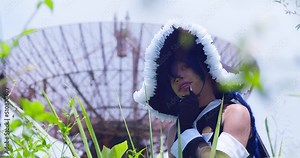 Wendy Belserion cosplayer in a large overgrown grass field with a radio tower in the background