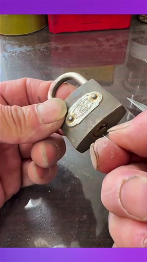 Unlocking the padlock using two pin ends with a quick and clever technique.
