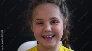 Happy little girl laughs. Cute baby face close up. Funny face of little girl. Happy cute baby smiling. Portrait of little girl close-up. Laughing of child indoors. Smiling cute little girl close up