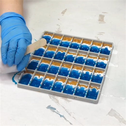 These beach resin dominoes are so fun and easy! You can use a variety of blues and can use real sand if you'd like, or simply a gold or tan resin color like I did here. Hope you like them :) | Mixed Media Girl