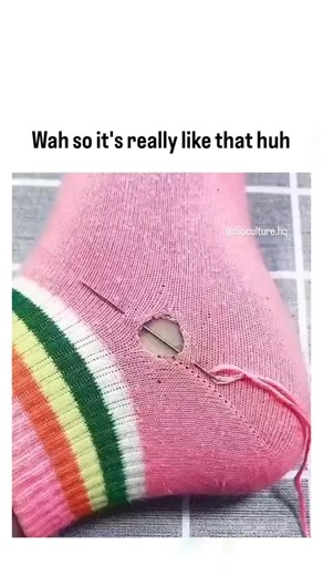dailysocialclips on Instagram: "The post features a 22-second silent video tutorial showing hands darning a hole in a pink sock with rainbow stripes using pink thread to form a Star of David shape, posted by @SasyaAnan990 , a user known for satirical content, on February 8, 2026. It satirizes the Israel-Palestine conflict by juxtaposing a sacred Jewish symbol with mundane sock repair, implying overreach or stereotype, amid ongoing global debates where such imagery often sparks accusations of bia