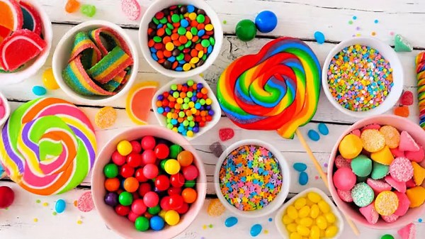 Colorful sweet candy buffet table scene. Slow rotating zoom motion. Top view over a white wood background Stock Video Footage - Alamy