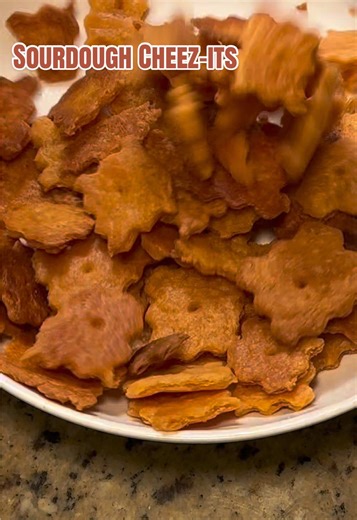 If you’re asking if that’s a playdoh cutter I’m using … yes.. yes it is Ingredients: 8oz shredded cheddar cheese 86g sourdough discard (room temp) 28g diced butter 1 tsp salt 66g AP flour Directions: -preheat oven to 350° -blend everything together in a food processor -once it forms into small dough balls, take out & finish kneading by hand -divide dough in half - roll out each half as thin as you can onto parchment paper -cut into cheez-it sized squares -poke holes in the center of each square 