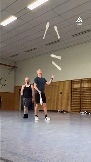 Duo Performs Juggling Trick With Five Clubs