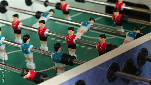 close-up of a table football game. table football playing field, table games competition red and blue teams.