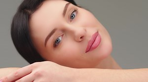 Beauty woman face isolated on backdrop background. Skin care. Beautiful female model with perfectly clean fresh skin. The concept of natural beauty and cosmetology