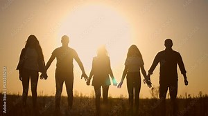 teamwork. team community a holding hands together silhouette at unity sunset. group of people hands. teamwork of workers. team in the company running partnership business community hand lifestyle