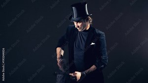 Pack of cards is turning into a top hat, cards appear from the air.