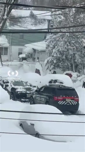 Police car stuck in snow, Citizen App video shows an officer trying to free his vehicle, surrounded by large piles of snow. Get real-time updates with Citizen 📲 | Citizen