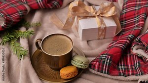 Fragrant coffee and sweet cookies on a blanket in Christmas. Gift in box
