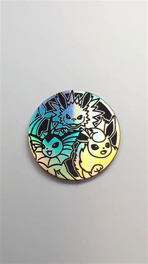 Custom Vaporeon, Jolteon, Flareon Eeveelution Pokèmon Coin. Sometimes things don't always go to plan and I still make mistakes. It happens but I try to take it as a learning experience. The center of Jolteons head is a little textured. It happened in the resin process. I'm pretty sure the paint in that area had a little too much water in it and while the resin was in the process of being cured it effected the surface of the paint. He looks like he has a little scruff on his head so it's not terr