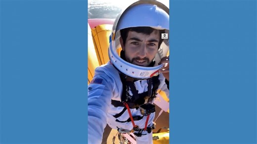 Man sets record for standing atop hot air balloon