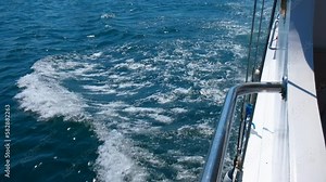 Yacht make water spray and foam. A motor modern yacht makes spray and foam in the sea. A concept of rapidly and extreme sea trip.
