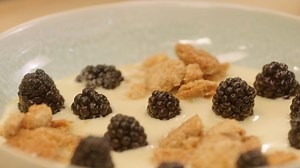 Fancy dessert plating with lemon curd and blackberries
