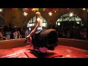 Girl riding a mechanical bull like a boss