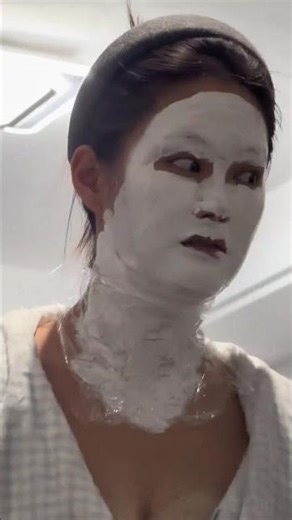 Woman wearing a scary white facial mask during a conversation in Zhejiang, China