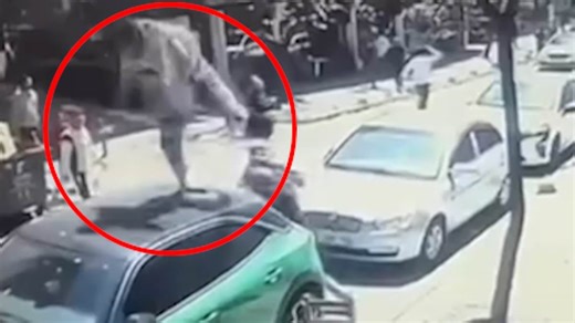 Shocking moment man tumbles onto car during earthquake and limps away